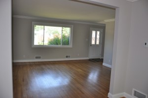View of front window and door from inside living room.